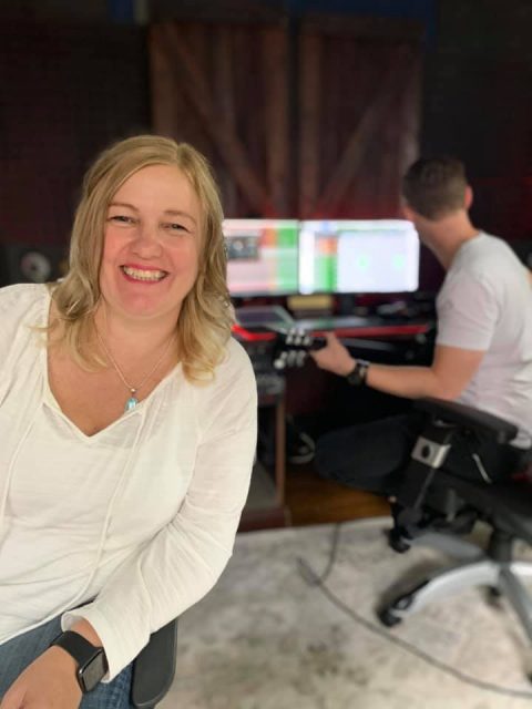 author in studio recording song with producer in Nashville
