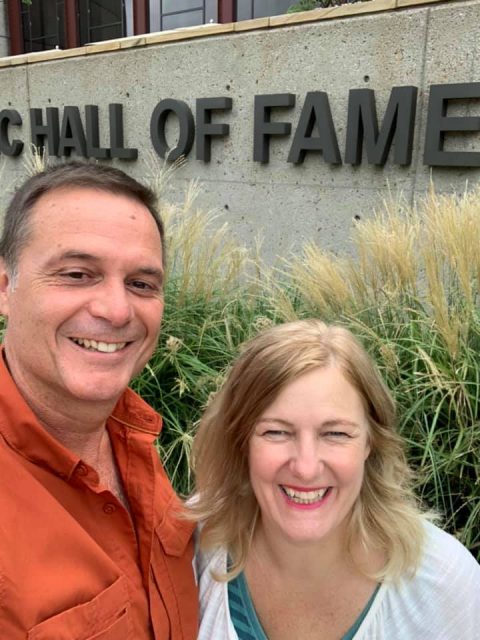 author and husband standing in front of the Country Music Hall of Fame in Nashville