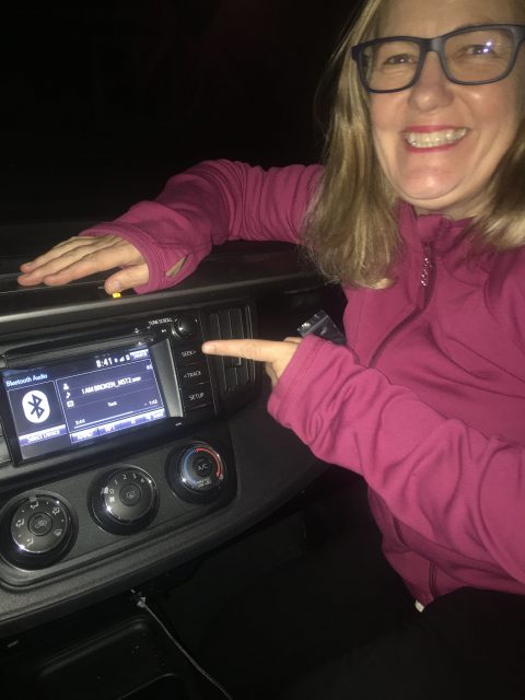author in car playing master of song over car radio via bluetooth